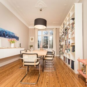 white and black chairs on brown wooden floor
